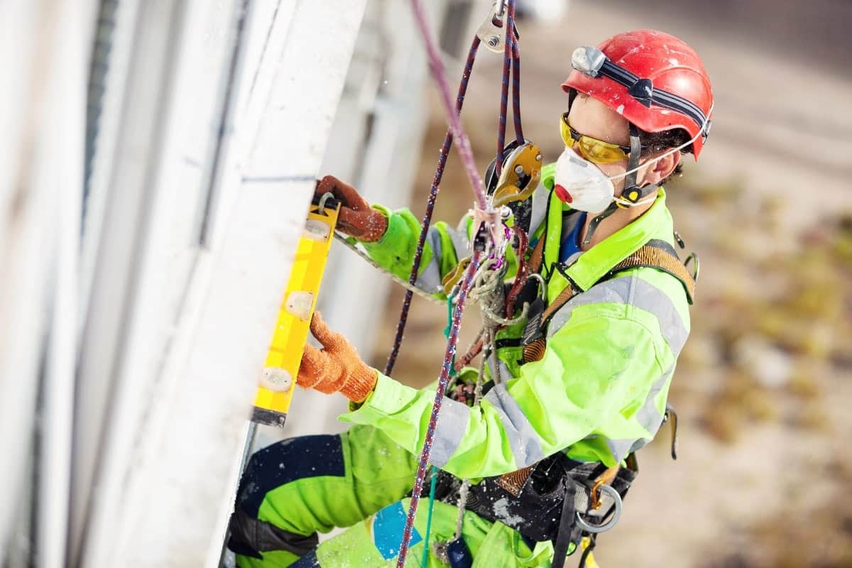 Image depicts working at heights as part of high risk construction jobs.