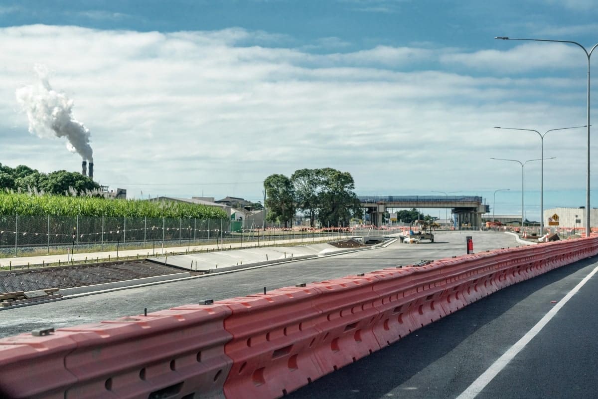 Long row of safety barriers on a road construction site.