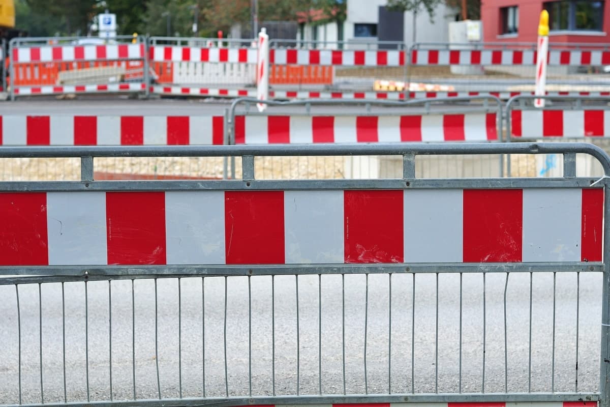 Rows of temporary barriers set up to keep workers safe in a construction area.