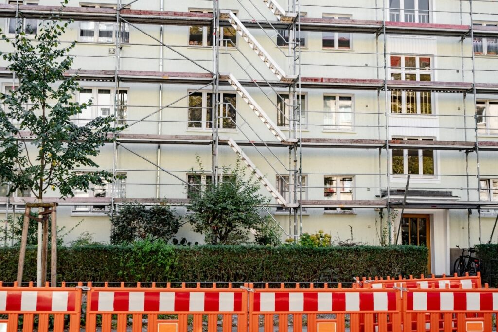 Frame scaffolding erected alongside a residential apartment building, showcasing its modular structure and ease of assembly for maintenance work.